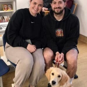 A man and a woman and a puppy